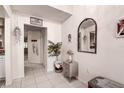 Bright condo entryway with mirror, small table, and coat rack at 2599 Dolly Bay Dr # 308, Palm Harbor, FL 34684