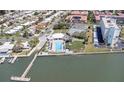 Aerial view of community pool, tennis courts, and waterfront access at 10216 Regal Dr # 708, Largo, FL 33774