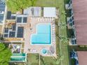 Aerial view showcasing a large pool, spa, and amenities within the community at 2400 Winding Creek Blvd # 25-101, Clearwater, FL 33761