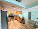 Modern kitchen with stainless steel appliances and wood cabinets at 3525 Eisenhower Dr, Holiday, FL 34691