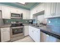 Modern kitchen with stainless steel appliances and white cabinets at 4411 Rustic Dr # 4411, New Port Richey, FL 34652