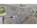 Living room with sectional sofa and ceiling fan at 1216 15Th S Ave, St Petersburg, FL 33705