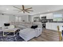 Open living room with large sectional sofa and adjacent kitchen at 1216 15Th S Ave, St Petersburg, FL 33705