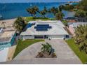 Waterfront home with large lot, solar panels, and concrete driveway at 4751 Baywood Point S Dr, Gulfport, FL 33711