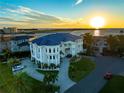 Waterfront mansion with a circular driveway and sunset views at 774 Nina Dr, Tierra Verde, FL 33715