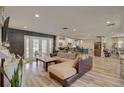 Spacious open-concept living room with hardwood floors and French doors to backyard at 7809 Alafia Dr, Riverview, FL 33578