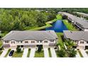 Townhomes with a pond view and lush green landscaping at 8520 Reedville St, New Port Richey, FL 34654