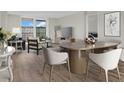 Bright dining room with light wood floors and a modern dining table at 9 Haig Pl # 612, Dunedin, FL 34698