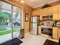 Bright kitchen featuring stainless steel appliances, and a sliding door to the outside at 6816 Dali Ave # 101, Land O Lakes, FL 34637