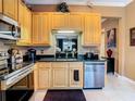 The kitchen showcases stainless steel appliances, sleek black countertops, and ample cabinet space at 6816 Dali Ave # 101, Land O Lakes, FL 34637