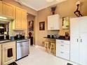 Kitchen with stainless steel appliances and light wood cabinets at 6816 Dali Ave # 101, Land O Lakes, FL 34637