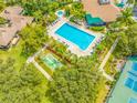 Community pool, tennis court, and bocce ball area at 1008 Blue Heron Way, Tarpon Springs, FL 34689
