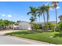 Single-story home with two-car garage and mature landscaping at 11220 9Th E St, Treasure Island, FL 33706
