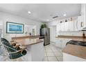 L-shaped kitchen with stainless steel appliances and a breakfast bar at 11220 9Th E St, Treasure Island, FL 33706