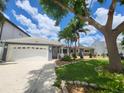 Single-Gathering home with a two-car garage and landscaped yard at 3912 Fontainebleau Dr, Tampa, FL 33634