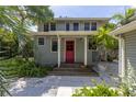 Two-story house with red door and stone pathway at 516 Gulf Blvd, Indian Rocks Beach, FL 33785