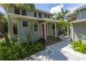 Two-story house with red door and stone pathway at 516 Gulf Blvd, Indian Rocks Beach, FL 33785