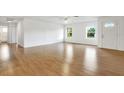 Spacious living room with light laminate flooring and large windows at 6700 90Th N Ave, Pinellas Park, FL 33782