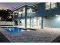 Two-story house with a pool and backyard at dusk at 83 Palm Blvd, Dunedin, FL 34698