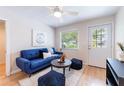 Bright living room with a blue sofa and ceiling fan at 4000 7Th N Ave, St Petersburg, FL 33713
