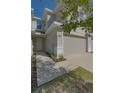 Front entrance and walkway to tan two-story townhome with garage at 2262 Montview Dr, Clearwater, FL 33763