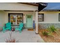 Inviting front porch with teal chairs and modern stone accents at 5511 13Th N Ave, St Petersburg, FL 33710