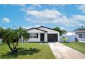 Charming one-story house with black garage door at 1861 Shore Acres Ne Blvd, St Petersburg, FL 33703