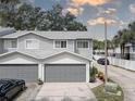 Two-car attached garage, gray doors, driveway parking at 9247 Jakes Path, Largo, FL 33771