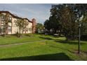 Landscaped grounds showcasing a well-maintained condo building and a peaceful neighborhood at 3455 Countryside Blvd # 15, Clearwater, FL 33761