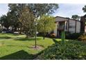 Charming condo building with manicured lawn, mature trees, and inviting curb appeal at 3455 Countryside Blvd # 15, Clearwater, FL 33761