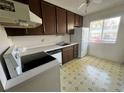 Simple kitchen with wood cabinets and appliances at 182 114Th Ne Ter # 182, St Petersburg, FL 33716