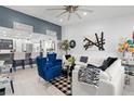 Bright living room with white sectional sofa and blue accent chairs at 2591 Countryside Blvd # 5304, Clearwater, FL 33761