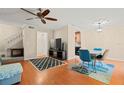 Living room featuring hardwood floors, a TV, and dining area at 11837 Wildeflower Pl, Temple Terrace, FL 33617