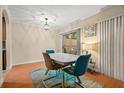 Bright dining room with hardwood floors and modern table set at 11837 Wildeflower Pl # 11837, Temple Terrace, FL 33617