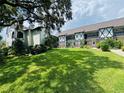 Tudor style condo building nestled in a serene, wooded setting at 400 N Bayshore Blvd # 104, Clearwater, FL 33759