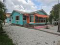 Quaint teal Florida bungalow with orange awning and pink trim at 3108 58Th S St, Gulfport, FL 33707