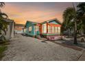 Evening view of teal Florida bungalow with orange awning at 3108 58Th S St, Gulfport, FL 33707