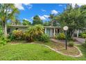 Landscaped front yard of a charming house with brick driveway at 2517 Trinidad St, Sarasota, FL 34231