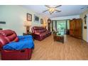 Living room with leather reclining furniture and wood floors at 865 Maclaren N Dr # D, Palm Harbor, FL 34684
