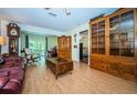 Spacious living room with hardwood floors, built-in shelving and access to patio at 865 Maclaren N Dr # D, Palm Harbor, FL 34684