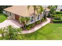 Aerial view of house with tile roof, landscaping, and driveway at 19003 Apian Way, Lutz, FL 33558