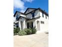 Two-story house with white exterior, landscaping, and a driveway at 1301 22Nd N Ave, St Petersburg, FL 33704