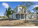 Two-story home with a front porch, landscaping, and walkway at 3839 71St N St, St Petersburg, FL 33709
