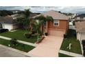 Two story house with palm trees and driveway at 2719 Mingo Dr, Land O Lakes, FL 34638