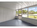 Bright screened porch overlooking the front yard at 109 W Grapefruit Cir, Clearwater, FL 33759