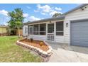 Inviting front porch with screened enclosure and gray flooring at 109 W Grapefruit Cir, Clearwater, FL 33759