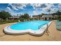 Community pool with lounge chairs and a shaded seating area at 8693 Bardmoor Blvd # 202B, Seminole, FL 33777