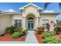 Inviting front entrance with double doors and lush landscaping at 22531 Eagles Watch Dr, Land O Lakes, FL 34639