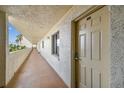 Hallway showing unit door with exterior walkway and palm tree views at 14950 Gulf Blvd # 404, Madeira Beach, FL 33708