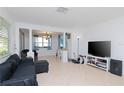 Bright living room with tile floors and a large TV at 219 6Th Sw Ave, Largo, FL 33770